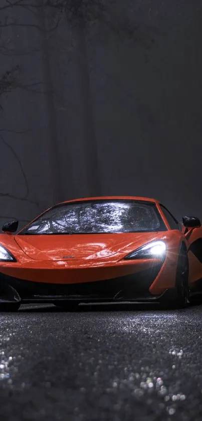 Vibrant orange sports car on a misty dark road.