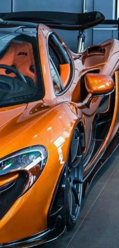 Sleek orange supercar in showroom setting.