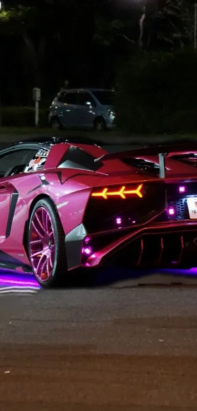 Pink sports car with neon lights on a night street.