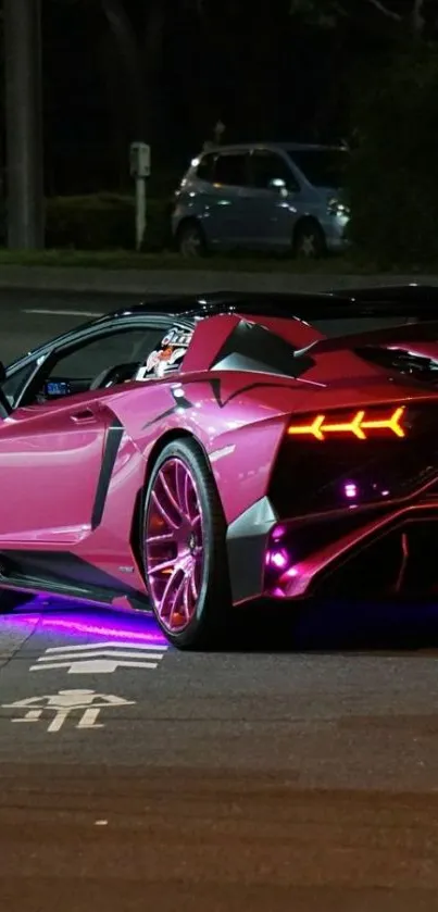 Sleek pink sports car with neon lights at night.