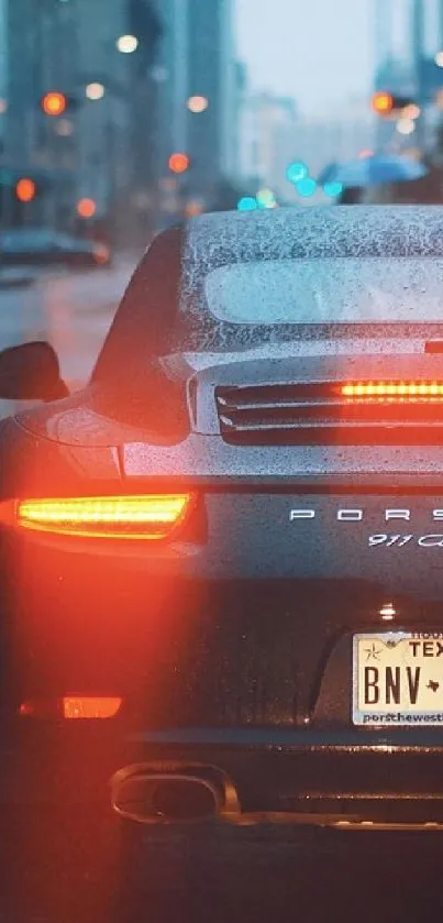 Porsche 911 driving through a rainy urban street at night.