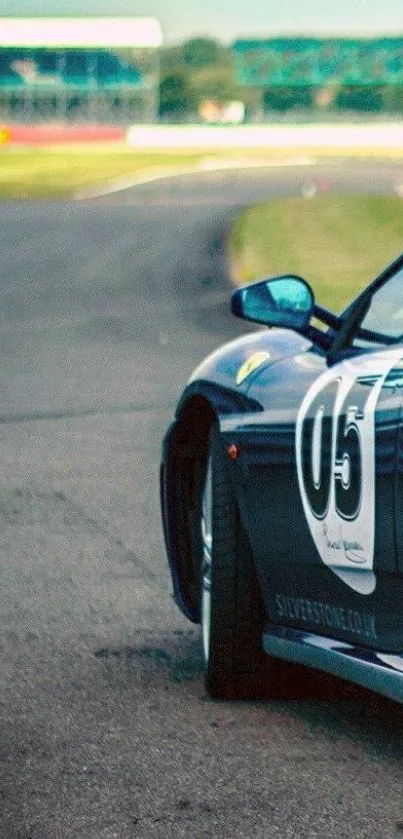 Sleek racing car on a curved track, vibrant blue tones.