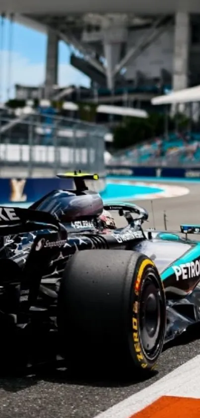 High-speed black racing car on track.