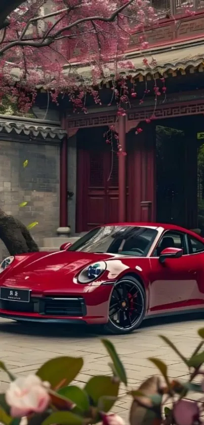 Sleek red car in Asian garden setting.