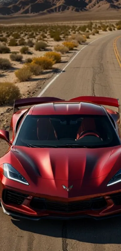 Red sports car driving on desert highway.