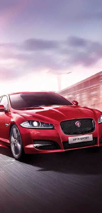 Sleek red car speeding with dynamic backdrop wallpaper.