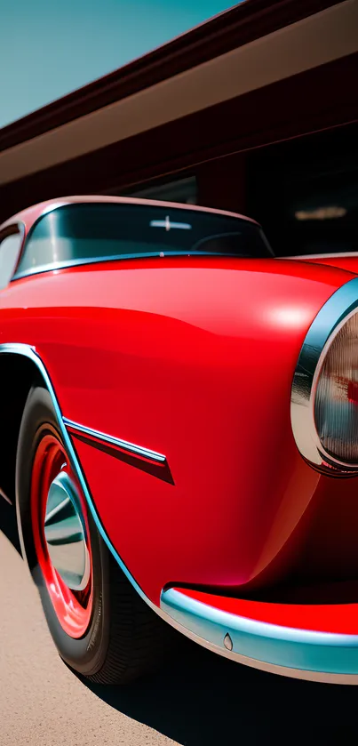 Close-up of a sleek red classic car's front view, perfect for mobile wallpaper.