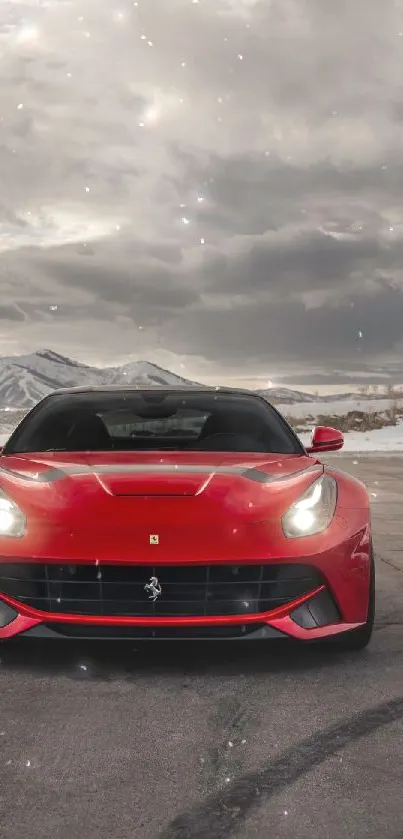 Red Ferrari with snowy mountain backdrop, perfect for mobile wallpaper.