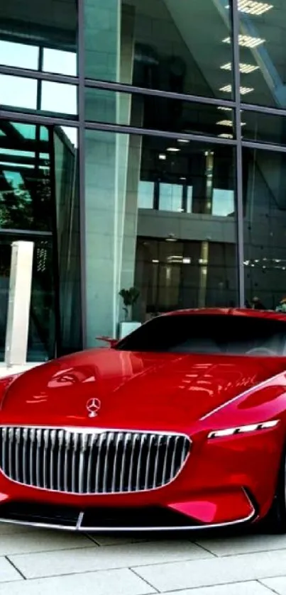 Red luxury car parked by glass building, perfect for mobile wallpaper.