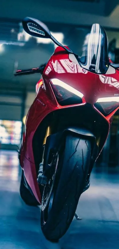 Red motorcycle in a stylish garage setting, frontal view.