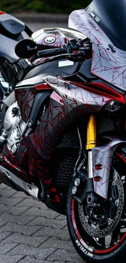 Sleek red sportbike with dynamic design on pavement.