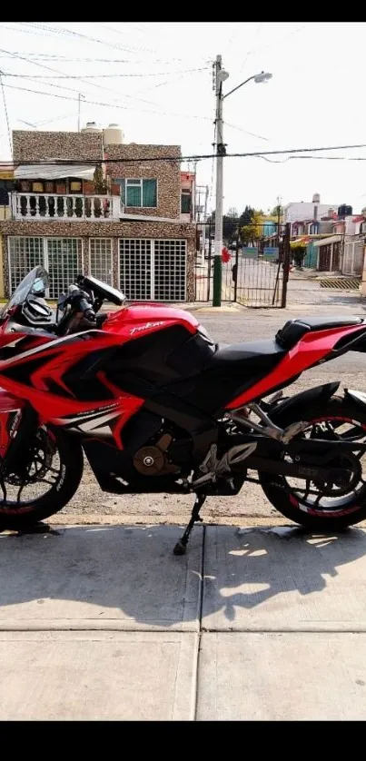 Sleek red sports bike parked on urban street.