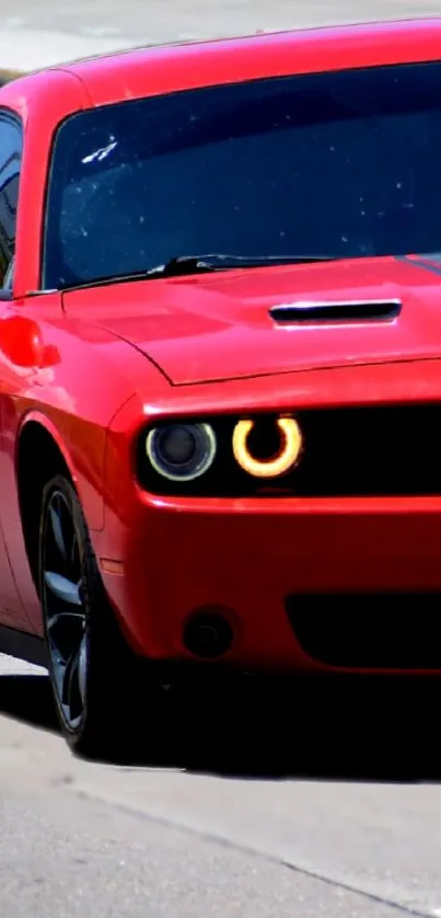 Sleek red sports car with LED headlights on the road.