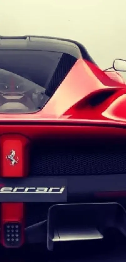 Red sports car rear view on dark background.