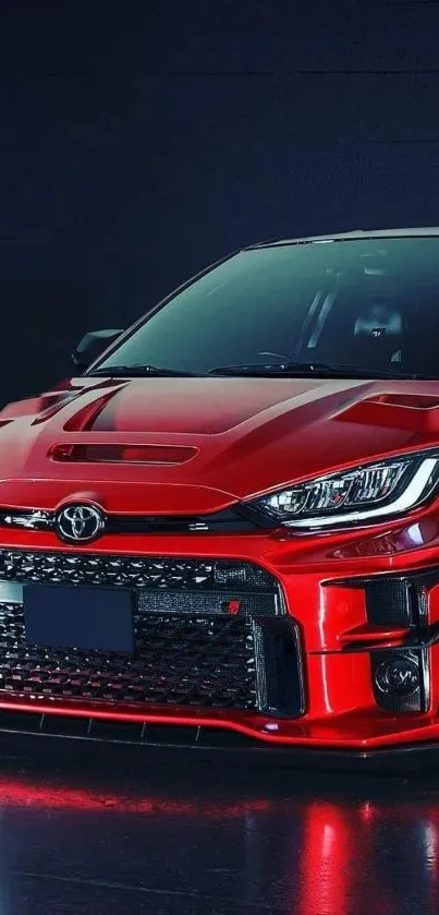 Sleek red sports car shines under dramatic lighting.