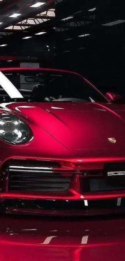 Luxurious red sports car in sleek showroom.