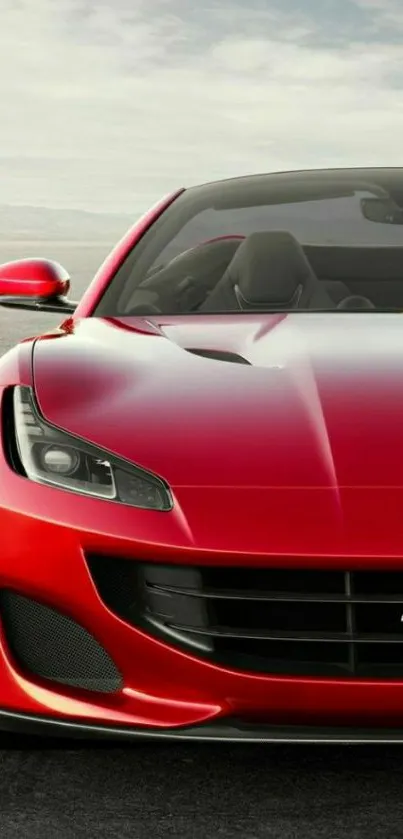 Red sports car on open road, sleek design.