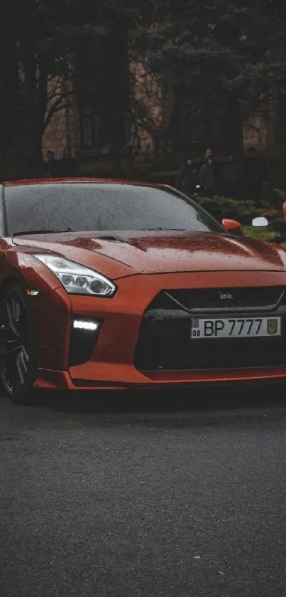 A sleek red sports car parked on a rainy street.