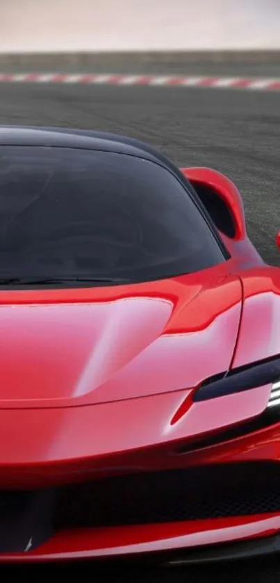 Red sports car on race track background.