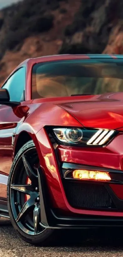 Red sports car on rocky mountain road.