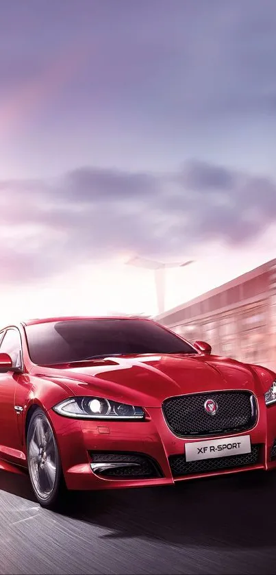 Sleek red sports car driving on a highway at dusk.