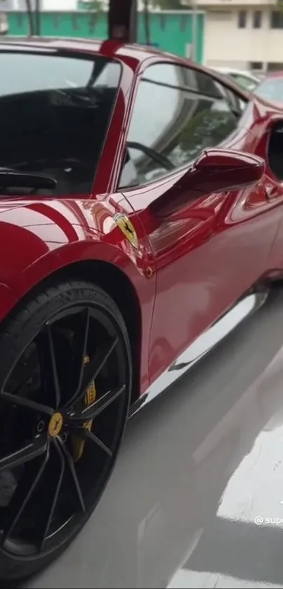 Sleek red sports car with glossy finish and reflective surface in garage.