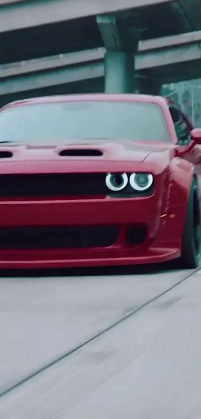 Sleek red sports car driving on a highway.