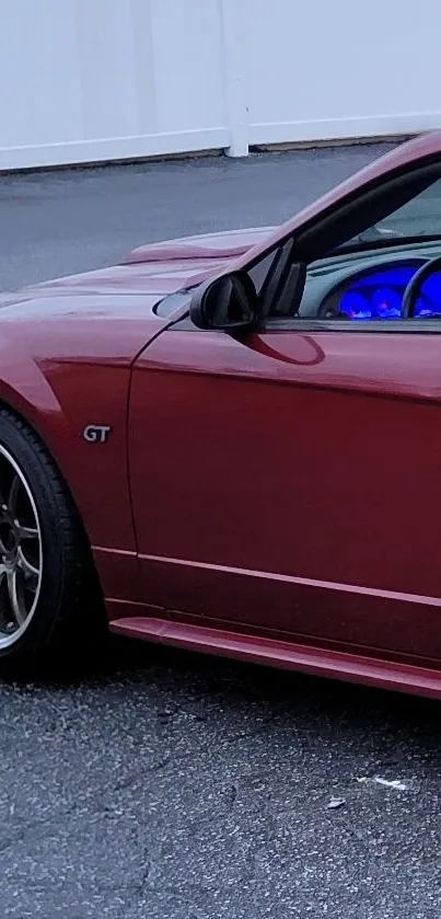 Red sports car close-up with GT emblem.