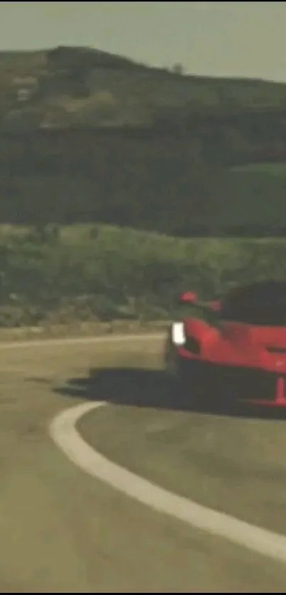 Red sports car driving on a scenic winding road.