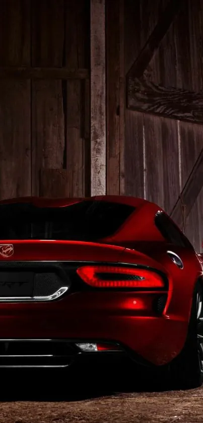 Sleek red sports car in wooden backdrop.