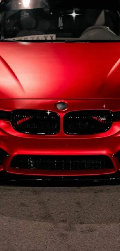 Sleek red sports car on a night road.