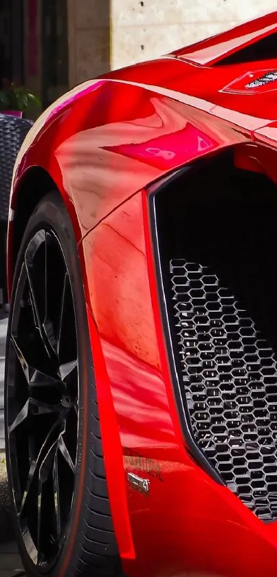 Closeup of sleek red sports car, showcasing luxury and dynamic design.