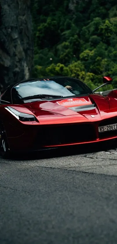 Red sports car speeding down a mountain road.