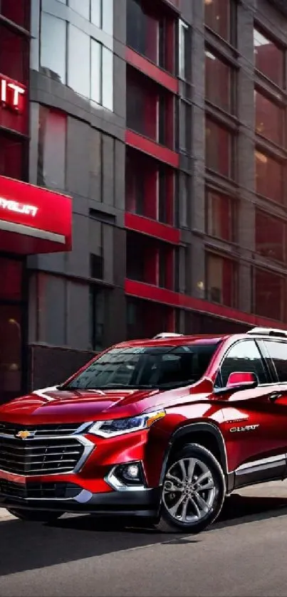 Sleek red SUV driving through a vibrant cityscape during the day.