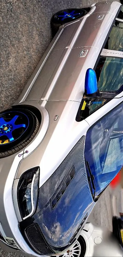 Sleek silver car with blue accents parked.