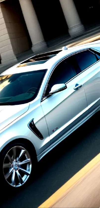 Sleek silver luxury sedan driving in cityscape.