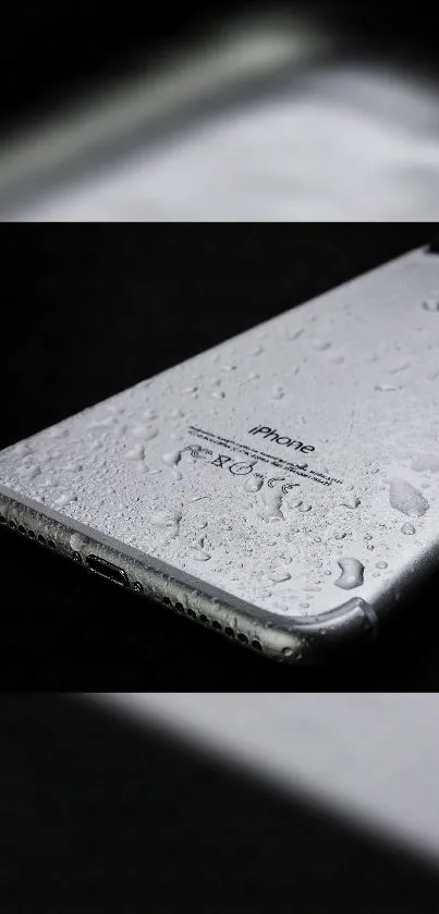 Sleek silver smartphone with water droplets.