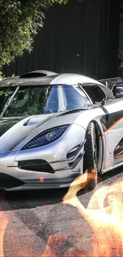 Silver sports car parked in a leafy street setting.