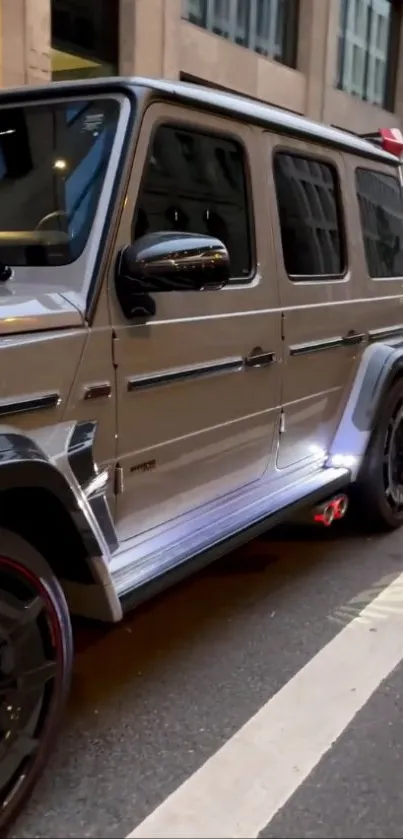 Luxury silver SUV parked on urban street.