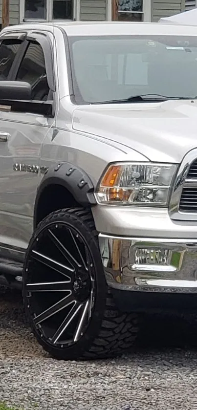 Silver truck with large black wheels, sharp details.