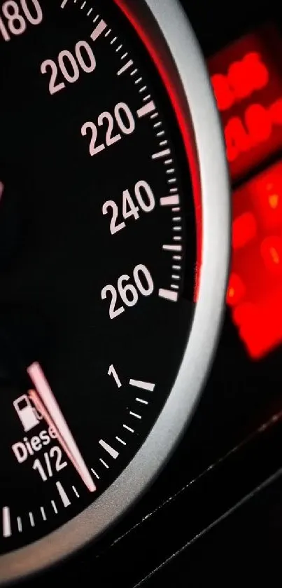 Close-up of a sleek car speedometer with red and black dials.