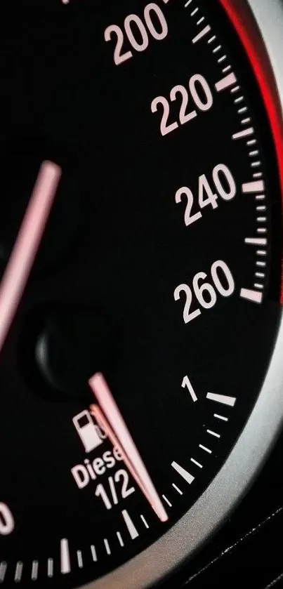 Close-up of a speedometer with black and red tones in sleek design.