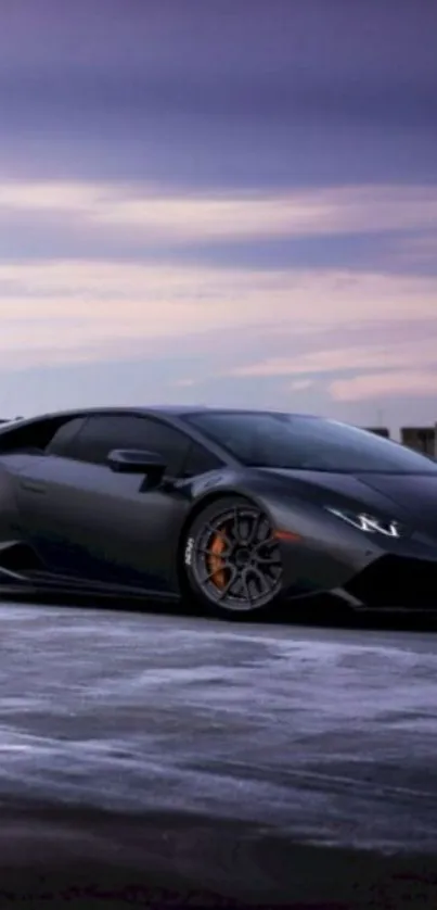 Sleek black sports car under a twilight sky on the parking lot.