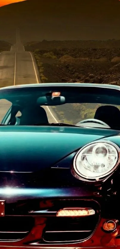 Sleek sports car on an open road at sunset with orange sky.