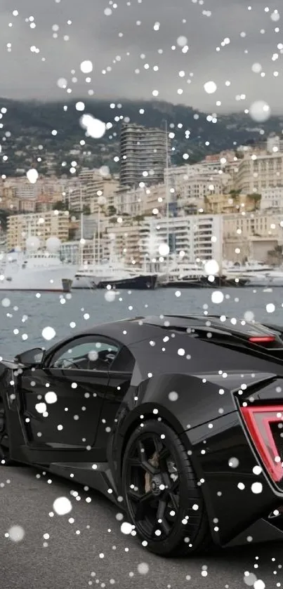 Black sports car parked by a seaside cityscape.