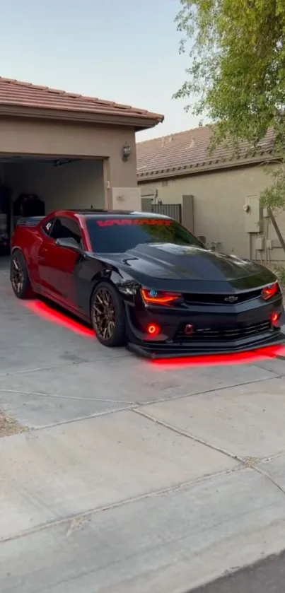 Black sports car with red lights on driveway.