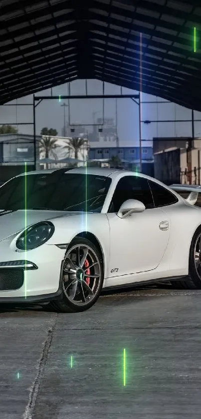 Sleek white sports car in industrial garage setting.