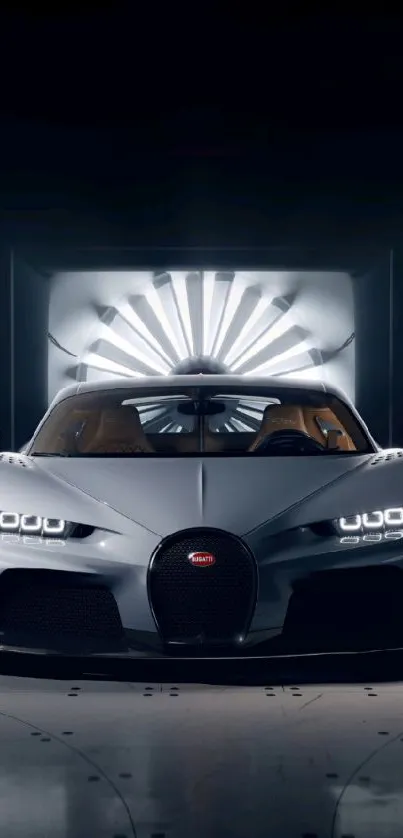 Front view of a sleek, grey sports car under studio lights.