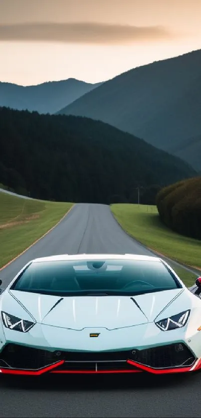 Sleek sports car driving on a scenic mountain road during sunset.