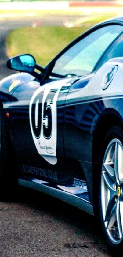 Sleek black sports car speeding on a racing track.